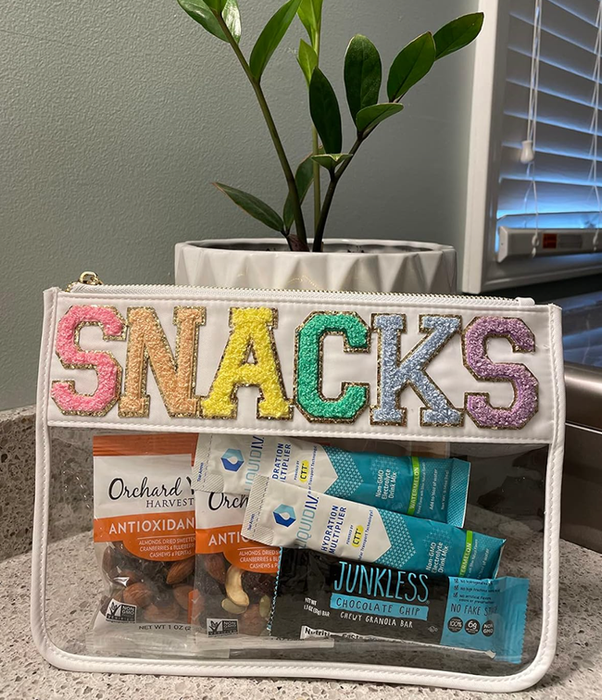 A clear, plastic snack bag with a white lining and the word displayed on it.