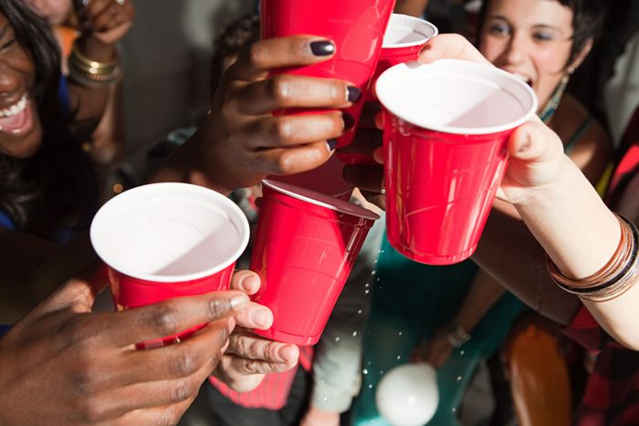 A group of people celebrating with red solo cups at an energetic gathering, radiating a feeling of joy and unity