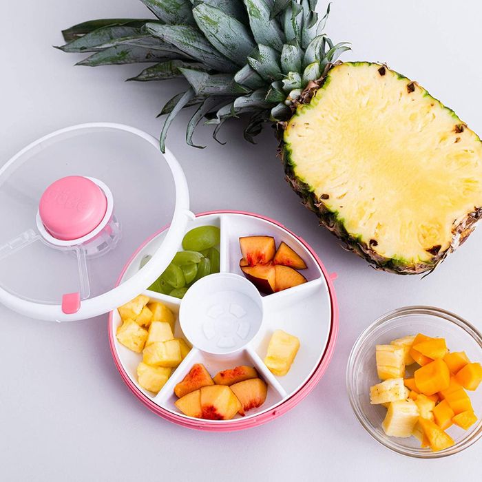 The circular snack spinner, featuring six compartments, each filled with food.