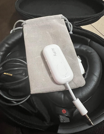 A small white device packed with travel essentials.