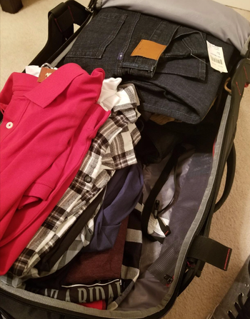 Before image showing clothes taking up too much space in a suitcase.