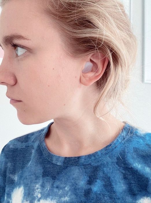 A Mytour editor wearing silicone earplugs in their ears.