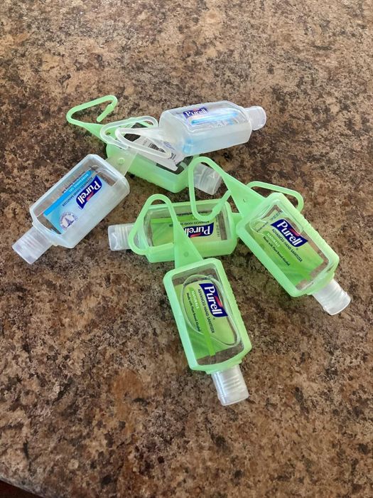 A reviewer showing a pack of hand sanitizers.