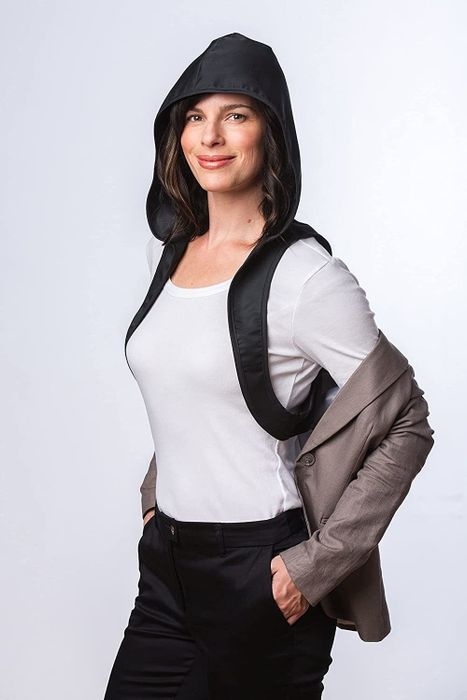 The model with the jacket open, showing how the hood is connected under the arms for attachment.