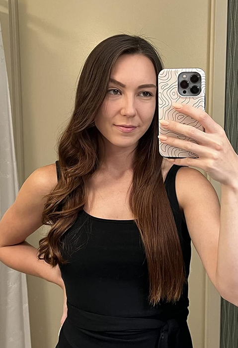 A reviewer with half-curled, half-straight hair.