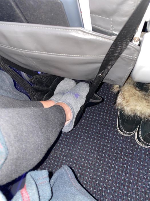 A reviewer relaxing with the hammock on a flight.
