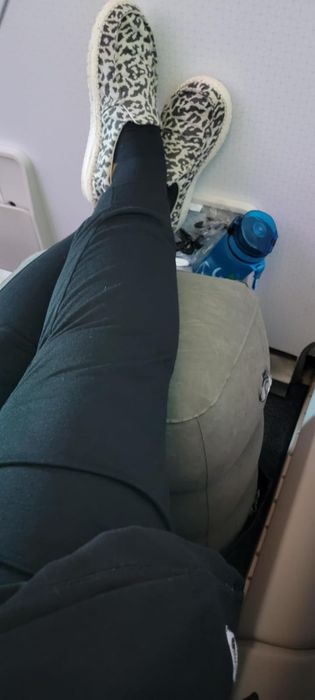 A reviewer enjoying the inflatable footrest during their flight.