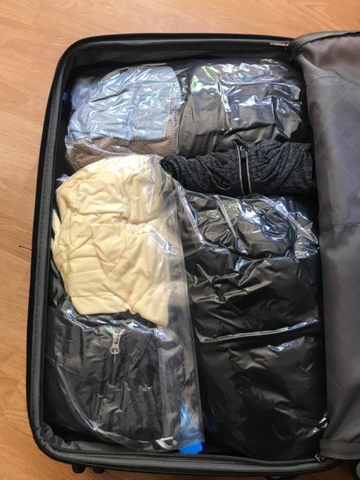A reviewer image showing the bags neatly packed in a suitcase.