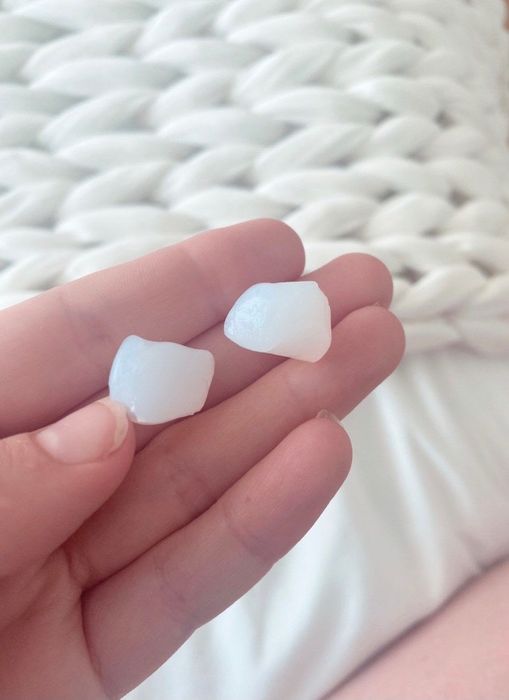 A shot of silicone earplugs resting gently in an editor's hands.