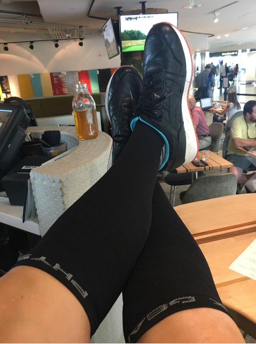 Black compression socks on a reviewer, extending up to their calf.