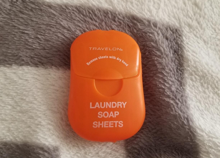 A reviewer image showing the bright orange laundry soap sheets.