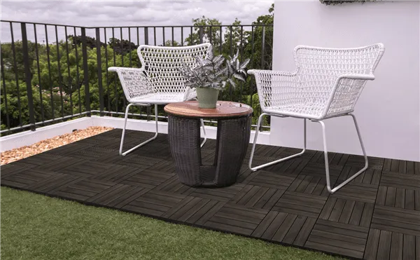 The deck tiles laid out beneath a patio set.