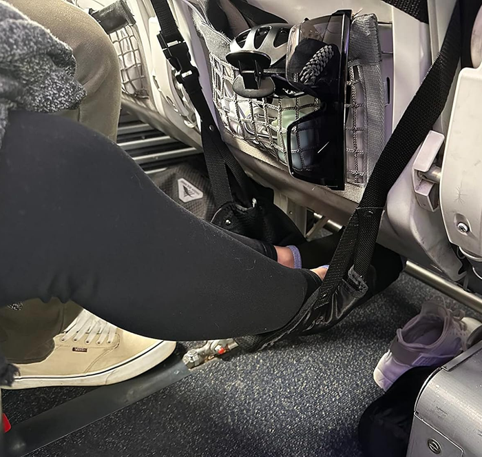 A reviewer making use of the hammock during a flight.