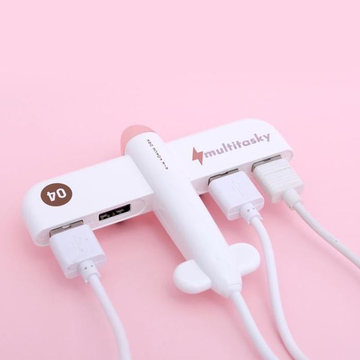 A white USB port with four slots designed to look like an airplane.
