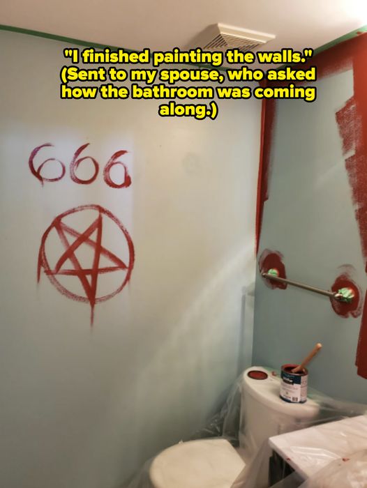 A bathroom being painted features the ominous number “666” and a pentagram, partially completed with red paint.