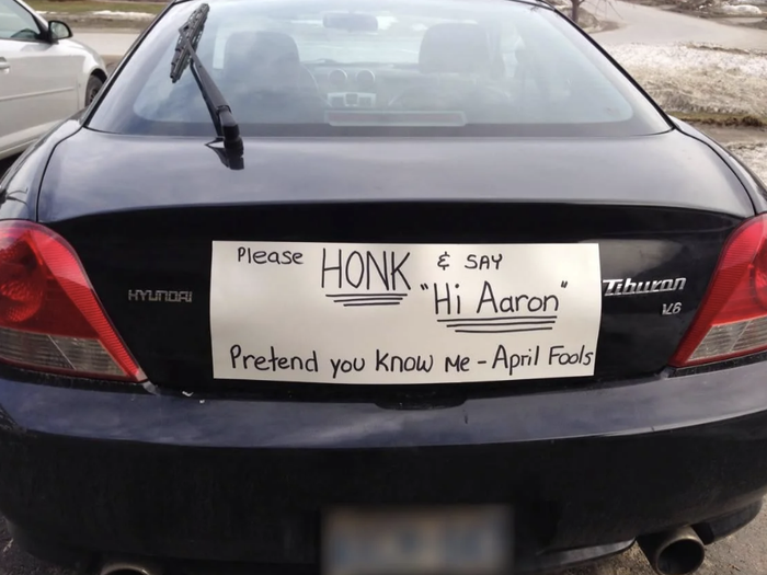A car with a sign that reads: