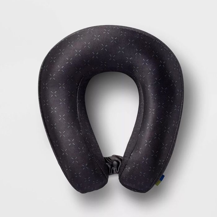 A sleek black neck pillow with a subtle pattern, offering travel comfort
