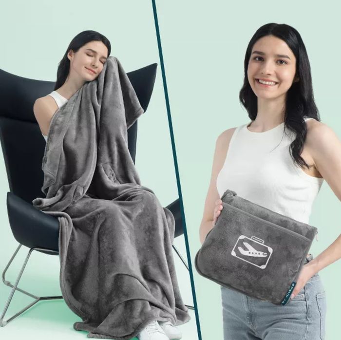 A model lounges in a chair wrapped in a plush blanket and stands holding the folded blanket in a convenient bag, smiling