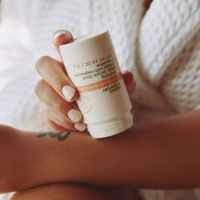 A model applying the soothing serum to their skin