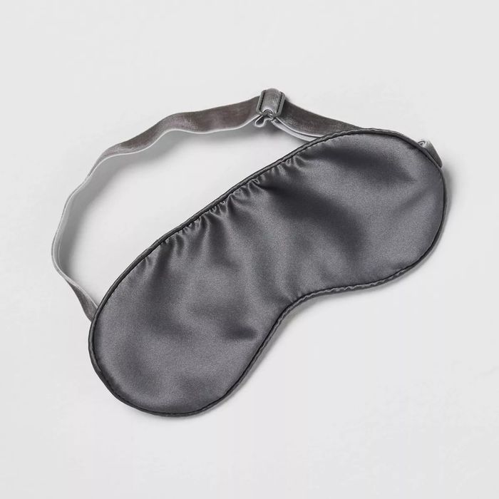 A luxurious silk sleep mask with an adjustable strap to improve your sleep experience
