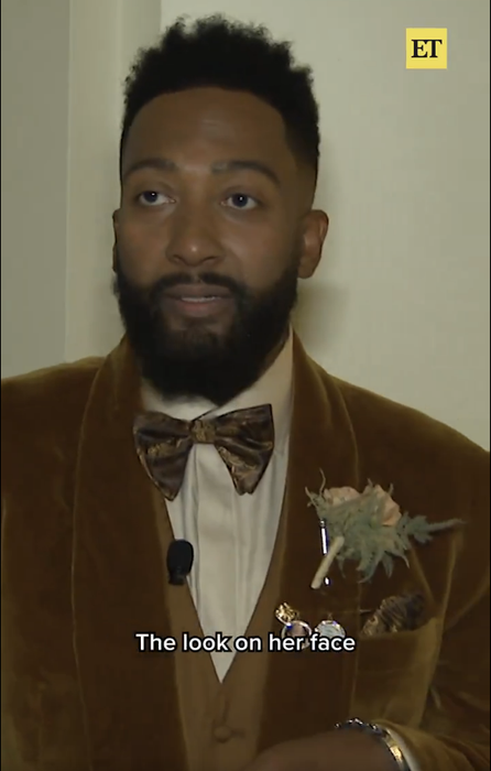 A man in a velvet suit and bow tie holds a microphone; accompanying text reads, 