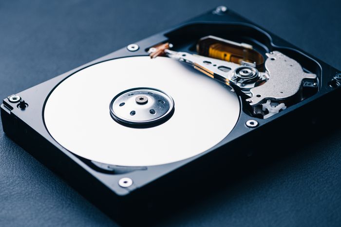 Close-up of an open hard disk drive revealing its internal components including the platters, spindle, and read/write arm