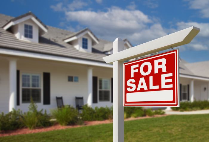 A 'For Sale' sign placed outside a home.