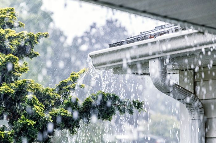A house getting drenched by rain.