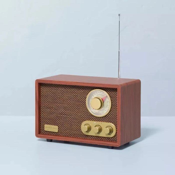 Vintage-inspired radio with a wooden exterior and retro knobs placed on a simple surface