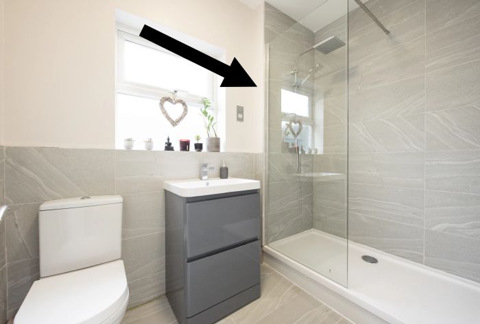 Arrow pointing toward a glass shower door