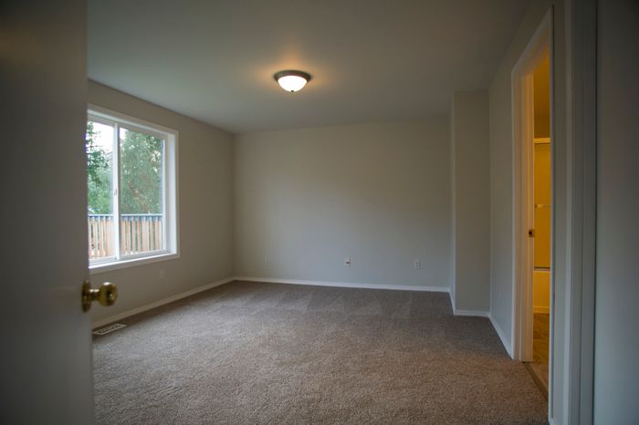 A vacant bedroom with no furnishings.