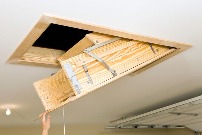 Someone pulling down an attic door.