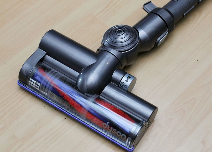 Dyson vacuum cleaner nozzle on a wooden floor