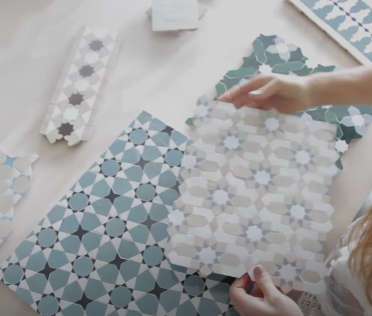 Person browsing through a variety of Moroccan-style tiles