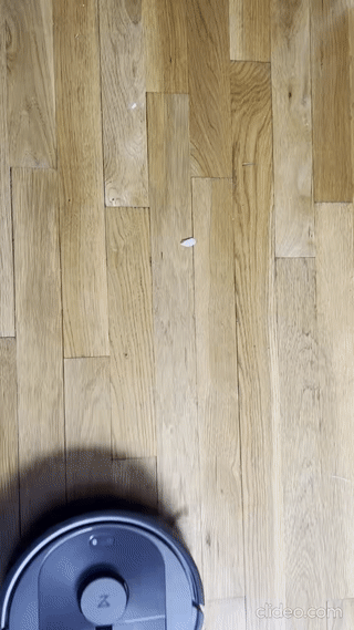 Roborock actively picking up dirt from the floor.
