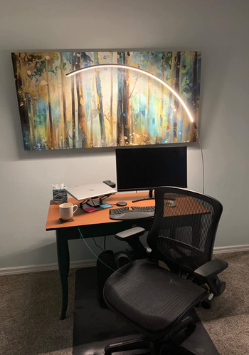 The same lamp casting a gentle glow over a desk