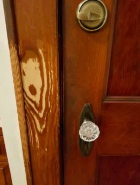 A reviewer’s photo showing a door frame with a faded finish