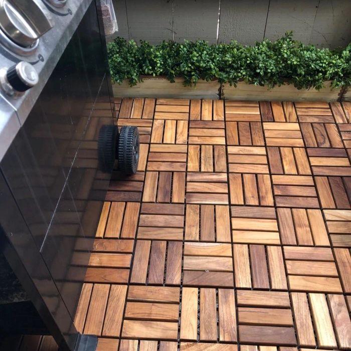 Wooden interlocking deck tiles laid on a patio surface