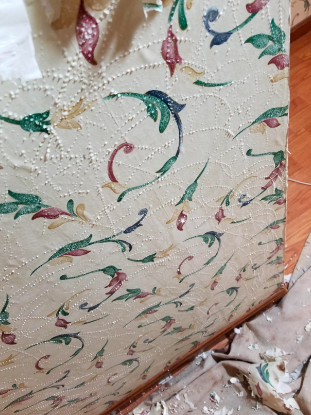 Reviewer beginning the process of stripping off the wallpaper