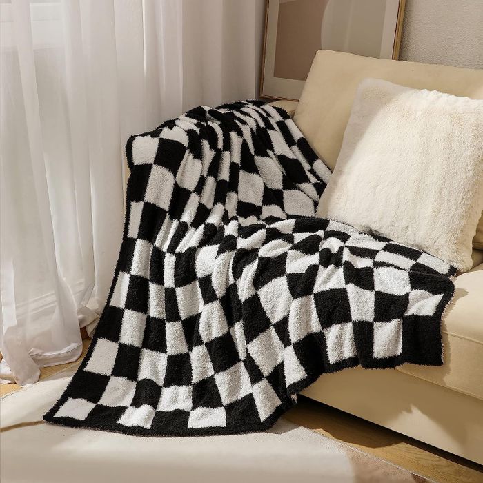 A black and white checkered throw blanket, stylish and irresistibly cozy.