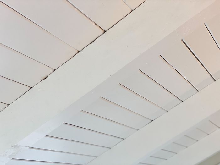 Ceiling with white painted wooden beams