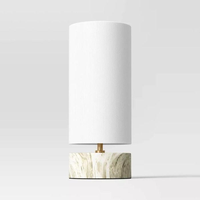 A lamp with a faux-marble base adding a touch of sophistication to the room