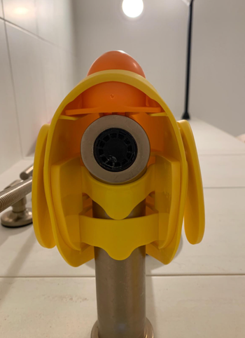 A close-up view of the exposed spout underneath the rubber ducky cover