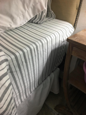 The same reviewer’s photo of the fitted sheet securely on the mattress as it should be after using the suspenders.