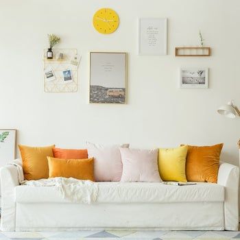 A selection of plush velvet pillow covers arranged on a stylish sofa.