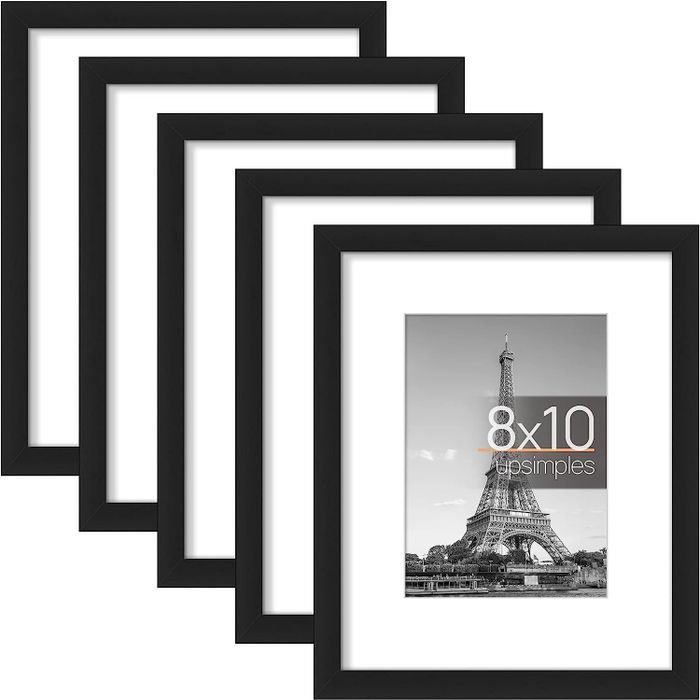 Five sleek black picture frames lined up together.