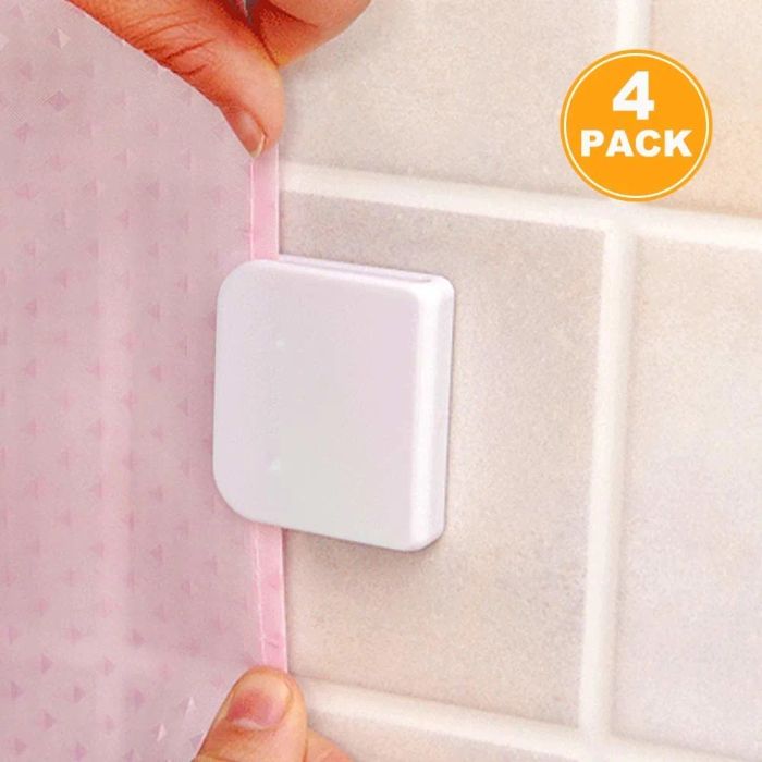 a curtain being placed into a clip attached to the wall