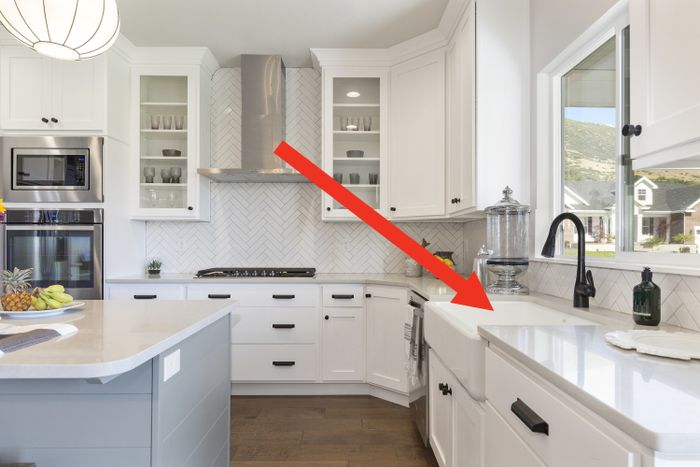 Farmhouse sink featured in a white kitchen setting