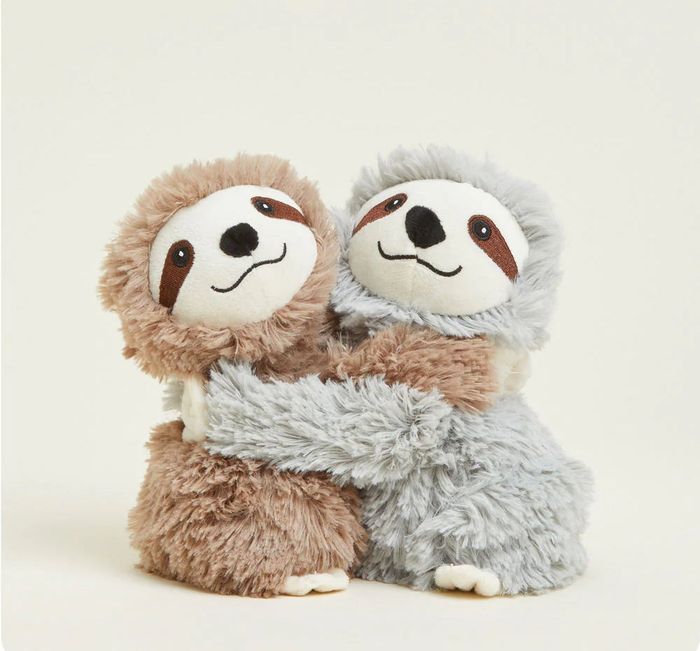 Two plush sloth toys embracing, one brown and one gray