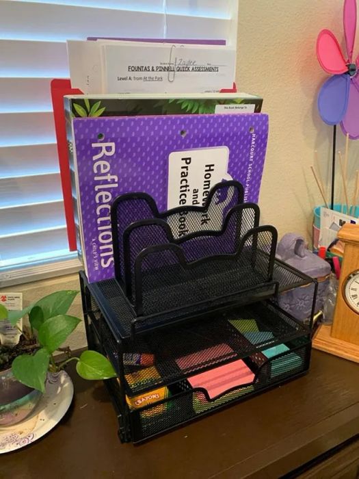 A reviewer's desk organizer filled with a variety of office supplies.